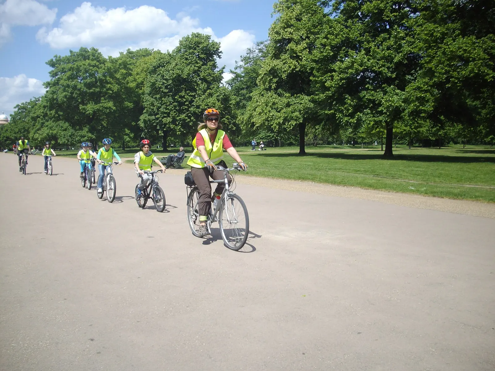 Children and their coach cycling in Hyde Park in London.